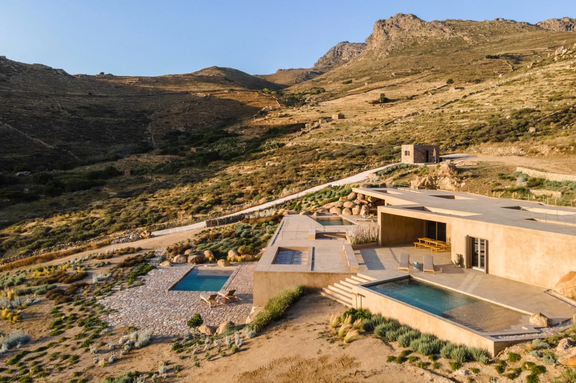 Stunning exterior of Homa Vagia, a luxury accommodation in Serifos, Greece, showcasing its unique architectural design.