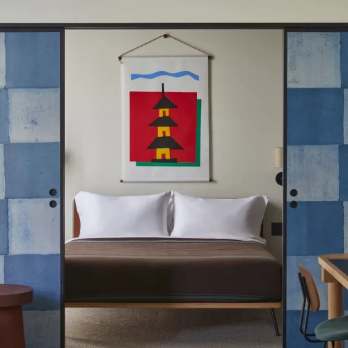 Cozy guest room at Ace Hotel Kyoto with contemporary decor and traditional Japanese elements.