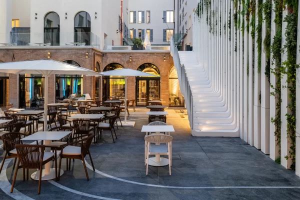 Romeo Roma hotel façade blending Renaissance architecture with contemporary design by Zaha Hadid Architects.