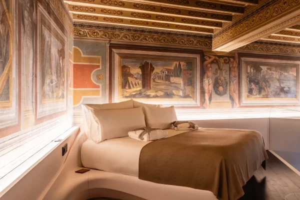 Romeo Roma guest room with bespoke furniture and restored 17th-century fresco.